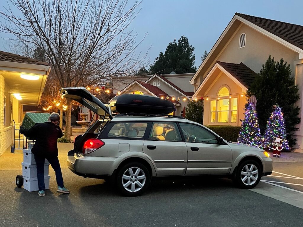 STEAC holiday program loading presents into car.