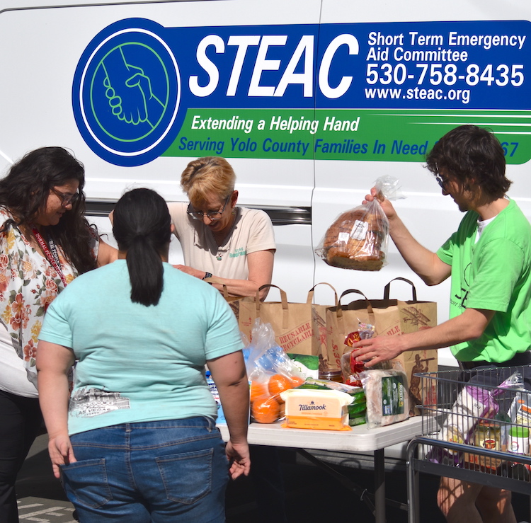 STEAC volunteers loaded food into bags